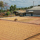 A worker on a tractor drying parchment coffee on a patio at San Miguel Mill in El Salvador.