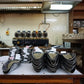 A coffee lab in Kenya showing shelves and tables containing scoops, bags. and sample roasters.